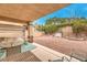 Covered patio with seating area and swing, overlooking low-maintenance backyard with gravel landscaping at 1970 Jasper Creek Pl, Las Vegas, NV 89123