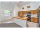 Spacious kitchen with butcher block island, tile floors, and ample natural light at 1970 Jasper Creek Pl, Las Vegas, NV 89123