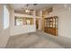 Open living room with carpet flooring, ceiling fan, and view into the kitchen at 1970 Jasper Creek Pl, Las Vegas, NV 89123