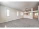 Bright living room with plantation shutters, neutral paint, and plush carpet at 1970 Jasper Creek Pl, Las Vegas, NV 89123