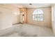 Spacious living room with natural light from the large arched windows and carpet flooring at 1970 Jasper Creek Pl, Las Vegas, NV 89123
