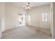 Large bedroom featuring carpet flooring, a ceiling fan, and a sliding glass door to the backyard at 1970 Jasper Creek Pl, Las Vegas, NV 89123