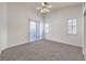 Bright main bedroom with a sliding door and windows, fresh paint, and plush carpet at 1970 Jasper Creek Pl, Las Vegas, NV 89123
