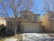 Two-story home featuring desert landscaping, tile roof, and a two-car garage at 2012 Nightrider Dr, Las Vegas, NV 89134