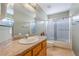 Bright bathroom features a granite vanity and shower-tub combination at 213 Red Coral Dr, Henderson, NV 89002