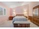 Bedroom with tile flooring, shuttered windows and traditional wood furniture at 213 Red Coral Dr, Henderson, NV 89002
