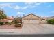 Charming single-story home with a two-car garage, desert landscaping, and a tile roof at 213 Red Coral Dr, Henderson, NV 89002