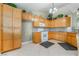Kitchen with wood cabinets, tile floors, and modern appliances at 213 Red Coral Dr, Henderson, NV 89002
