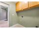Practical laundry area with overhead storage and tiled floors at 213 Red Coral Dr, Henderson, NV 89002