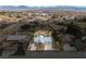 Wide aerial view of the property showcasing the pool, landscaping, and neighborhood with mountain backdrop at 2281 Wagon Ave, Pahrump, NV 89048