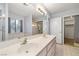 Bright bathroom with dual sinks, a soaking tub, and a spacious closet for storage solutions at 2281 Wagon Ave, Pahrump, NV 89048