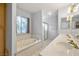 Bathroom features a large tub, shower, double sinks and bright vanity lights at 2281 Wagon Ave, Pahrump, NV 89048