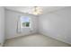 Cozy bedroom with carpeted floors, ceiling fan, and large window with curtains at 2281 Wagon Ave, Pahrump, NV 89048