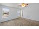 Bright bedroom showcasing neutral carpet, light walls, and large windows offering natural light at 2281 Wagon Ave, Pahrump, NV 89048
