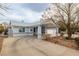 A view of a single-story home featuring a wide driveway and xeriscaping, reflecting a desert lifestyle at 2281 Wagon Ave, Pahrump, NV 89048