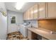 Functional laundry area with a full-size washer and dryer, ample cabinetry, and a convenient workspace at 2281 Wagon Ave, Pahrump, NV 89048