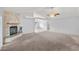 Spacious living room with a stone fireplace, neutral carpet, and ample natural light at 2281 Wagon Ave, Pahrump, NV 89048