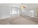 Spacious living room featuring carpet floors, ceiling fan, and stone fireplace at 2281 Wagon Ave, Pahrump, NV 89048