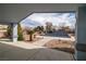 Framed view of backyard pool and landscaping from a covered patio at 2281 Wagon Ave, Pahrump, NV 89048