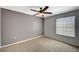 Cozy bedroom with neutral walls, carpet, ceiling fan, and natural light from the window at 231 W Horizon Ridge Pkwy # 426, Henderson, NV 89012