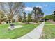 Well-maintained community park with a picnic area, sidewalk, trash receptacle, and mature trees at 231 W Horizon Ridge Pkwy # 426, Henderson, NV 89012