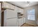 Functional kitchen with white appliances, cabinets, sink and vinyl flooring with great light at 231 W Horizon Ridge Pkwy # 426, Henderson, NV 89012