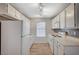 Bright, modern kitchen boasts white cabinets, appliances, and flooring with ample storage at 231 W Horizon Ridge Pkwy # 426, Henderson, NV 89012
