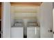 A laundry room features a washer, dryer, and shelving inside of a utility closet at 231 W Horizon Ridge Pkwy # 426, Henderson, NV 89012