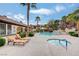 Resort-style pool and hot tub with lounge chairs, palm trees, and covered seating areas creating an inviting outdoor space at 231 W Horizon Ridge Pkwy # 426, Henderson, NV 89012