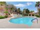 Community pool showcasing a tranquil waterfall feature and shaded seating areas for residents at 231 W Horizon Ridge Pkwy # 426, Henderson, NV 89012