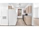 Well-lit kitchen with white fridge, wood cabinets, and modern appliances for a convenient cooking experience at 231 W Horizon Ridge Pkwy # 812, Henderson, NV 89012
