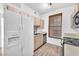 A functional kitchen with white appliances, light wood cabinets, and a window with wood blinds at 231 W Horizon Ridge Pkwy # 812, Henderson, NV 89012