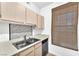 Compact kitchen featuring stainless steel sink, modern faucet, and a window with natural light at 231 W Horizon Ridge Pkwy # 812, Henderson, NV 89012