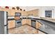 Kitchen with stainless appliances, ample cabinetry, counter seating, and tiled flooring at 231 W Horizon Ridge Pkwy # 812, Henderson, NV 89012