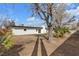Picture of a generous backyard and modern home with manicured trees and a wood fence at 2837 Reynolds Ave, North Las Vegas, NV 89030
