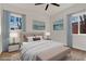 Bright bedroom featuring wood floors, two large windows, and neutral decor at 2837 Reynolds Ave, North Las Vegas, NV 89030