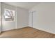 Bright bedroom features wood-look flooring, a window view, and a closet with sliding doors at 2837 Reynolds Ave, North Las Vegas, NV 89030