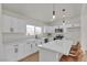 Bright kitchen with white cabinets, quartz countertops, stainless steel appliances, and eat-in island at 2837 Reynolds Ave, North Las Vegas, NV 89030