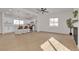 Open-concept living area with wood floors and bright lighting connected to the kitchen and fireplace at 2837 Reynolds Ave, North Las Vegas, NV 89030
