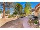 Private backyard featuring gravel landscaping with a covered patio area, perfect for outdoor enjoyment and entertainment at 3040 Ocean Port Dr, Las Vegas, NV 89117