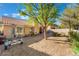 Large backyard with gravel, patio, mature trees and a boat trailer at 3040 Ocean Port Dr, Las Vegas, NV 89117