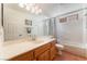 Bathroom featuring dual sinks, a shower-tub combo and great lighting at 3040 Ocean Port Dr, Las Vegas, NV 89117
