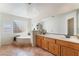 Bright bathroom features a soaking tub with glass block window, dual sink vanity and great lighting at 3040 Ocean Port Dr, Las Vegas, NV 89117