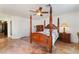 Bedroom features four poster bed, light-colored walls, shuttered windows, and a ceiling fan at 3040 Ocean Port Dr, Las Vegas, NV 89117