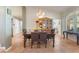 Bright dining area featuring a stylish chandelier, table, and natural light streaming through the windows at 3040 Ocean Port Dr, Las Vegas, NV 89117