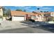 Charming single-Gathering home featuring a tile roof, a two-car garage, and a well-maintained front yard landscape at 3040 Ocean Port Dr, Las Vegas, NV 89117