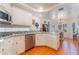Well-lit kitchen showcasing white cabinets, granite countertops, and stainless steel appliances at 3040 Ocean Port Dr, Las Vegas, NV 89117