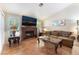 Cozy living room features a brick fireplace, plantation shutters, and tile flooring for a warm and inviting atmosphere at 3040 Ocean Port Dr, Las Vegas, NV 89117