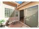 Private patio with tiled floors and elegant white furniture, perfect for relaxing at 3040 Ocean Port Dr, Las Vegas, NV 89117