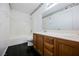 Bright bathroom featuring a modern bathtub, vanity with a white countertop, and sleek tile floors at 3087 Key Largo Dr # 202, Las Vegas, NV 89120